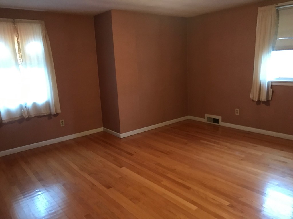 79 Haller Street Springfield, MA 01151 - Photo 23 of 26 an empty room with wooden floor and windows