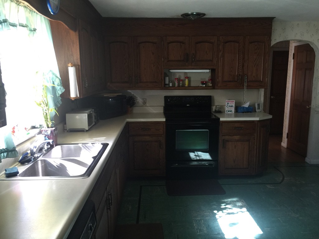 79 Haller Street Springfield, MA 01151 - Photo 4 of 26 a kitchen with granite countertop stainless steel appliances and wooden cabinets