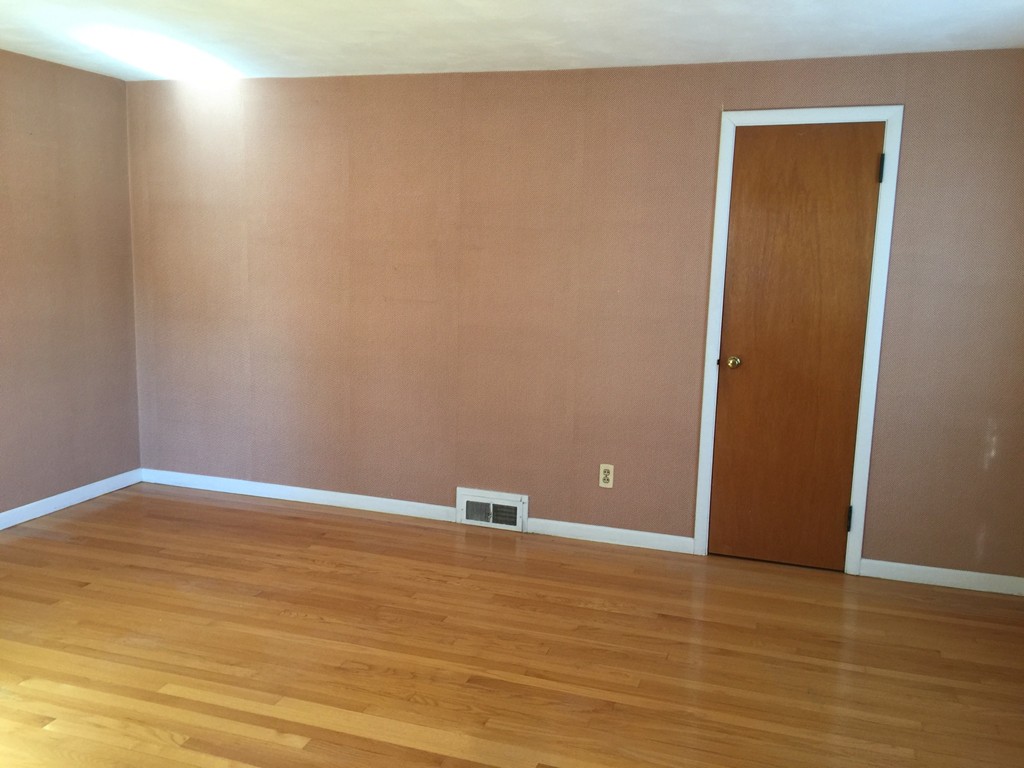 79 Haller Street Springfield, MA 01151 - Photo 9 of 26 a view of an empty room with wooden floor and a window