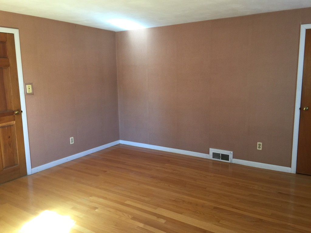 79 Haller Street Springfield, MA 01151 - Photo 10 of 26 a view of an empty room with wooden floor and a window