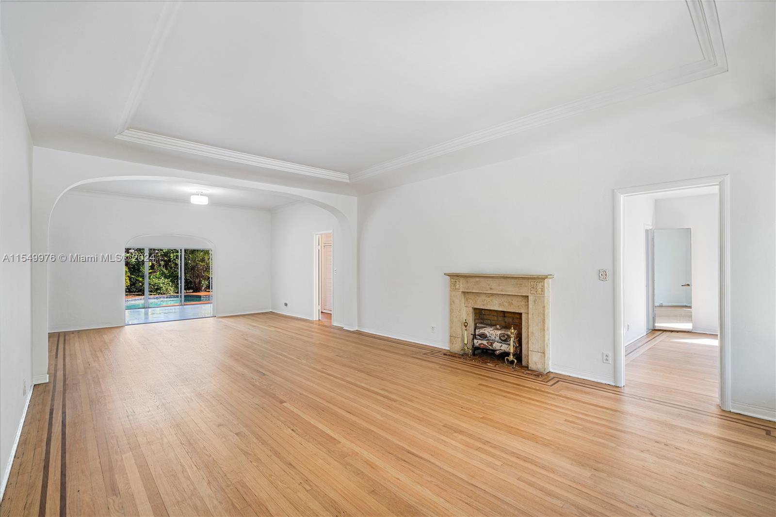 2935 North Bay Road Miami Beach, FL 33140 - Photo 11 of 36 an empty room with wooden floor and a fireplace