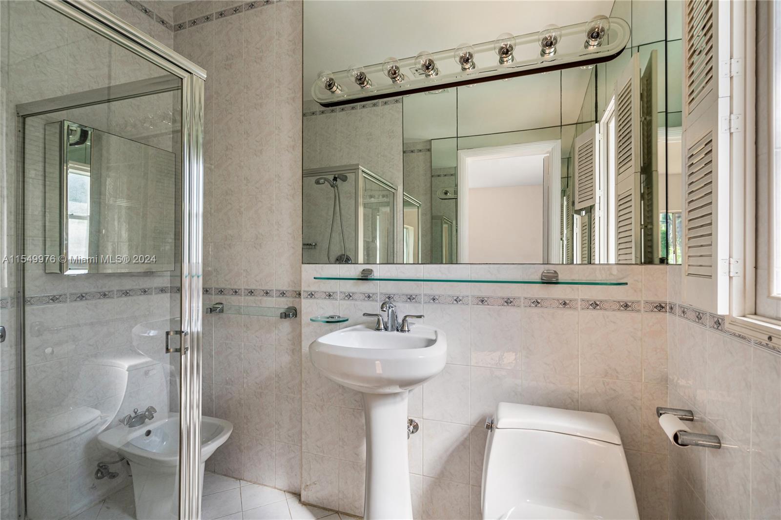 2935 North Bay Road Miami Beach, FL 33140 - Photo 15 of 36 a bathroom with a sink toilet and shower