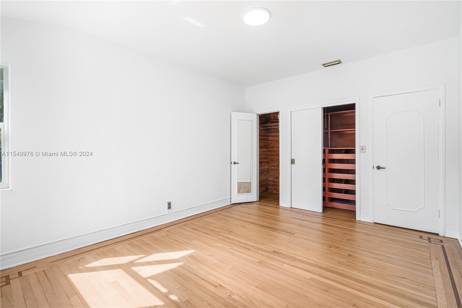 2935 North Bay Road Miami Beach, FL 33140 - Photo 17 of 36 a view of empty room with wooden floor and fan