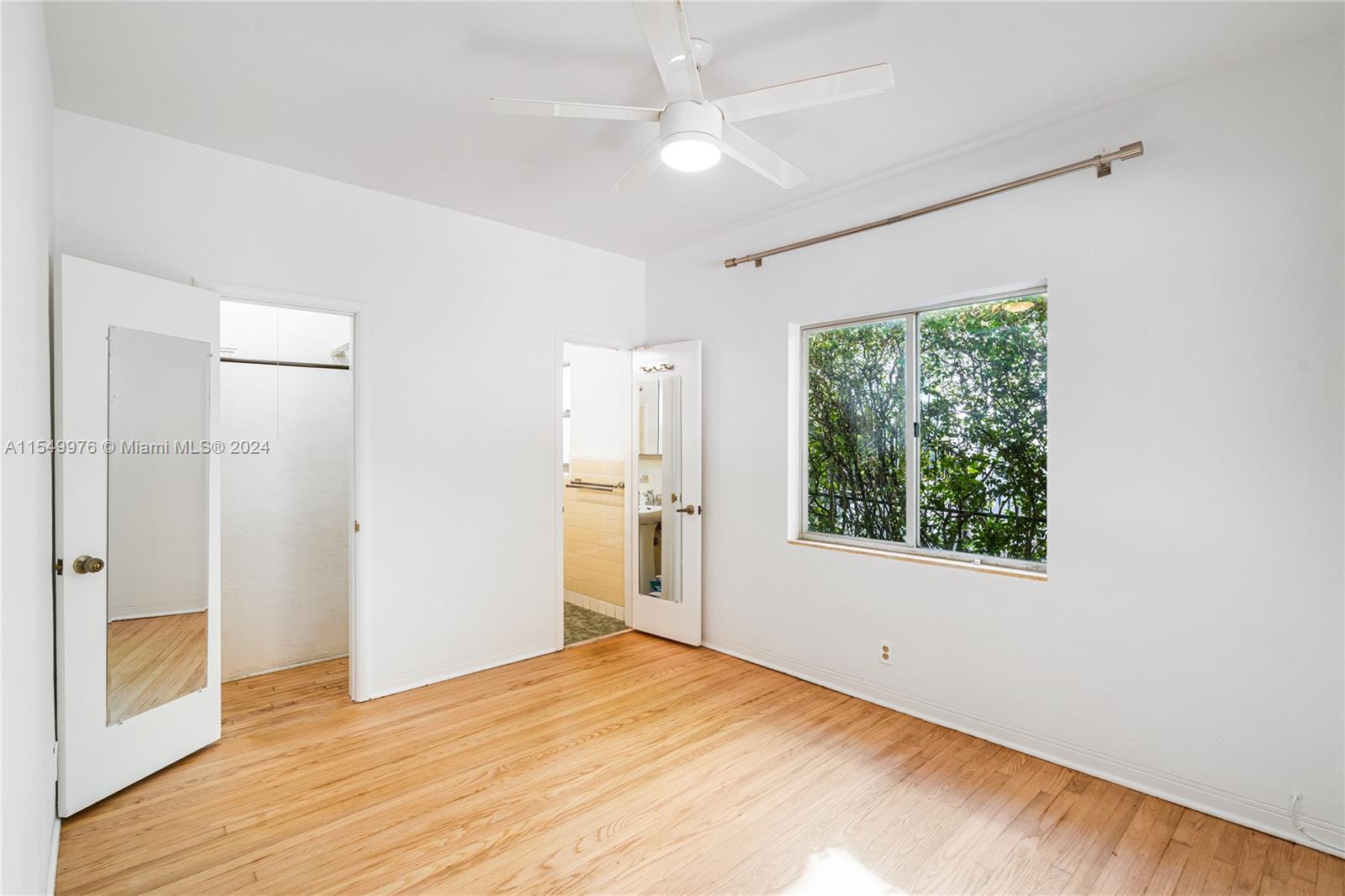2935 North Bay Road Miami Beach, FL 33140 - Photo 24 of 36 a view of empty room with wooden floor and fan