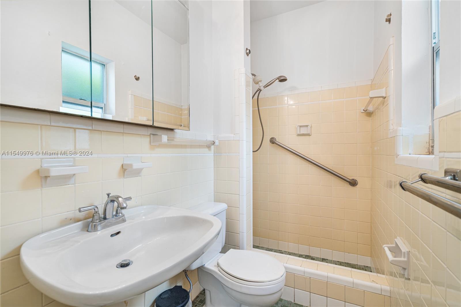 2935 North Bay Road Miami Beach, FL 33140 - Photo 25 of 36 a bathroom with a sink a toilet and shower