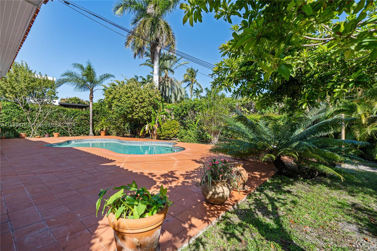 2935 North Bay Road Miami Beach, FL 33140 - Photo 30 of 36 a view of a swimming pool with a yard