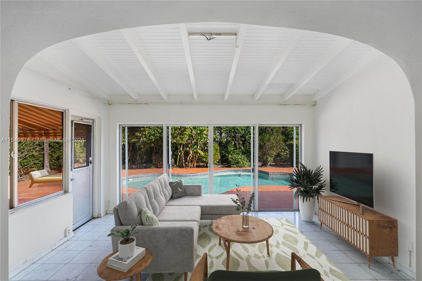 2935 North Bay Road Miami Beach, FL 33140 - Photo 4 of 36 a living room with furniture and a flat screen tv