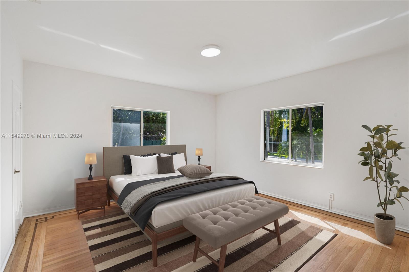 2935 North Bay Road Miami Beach, FL 33140 - Photo 7 of 36 a bedroom with a bed and a window