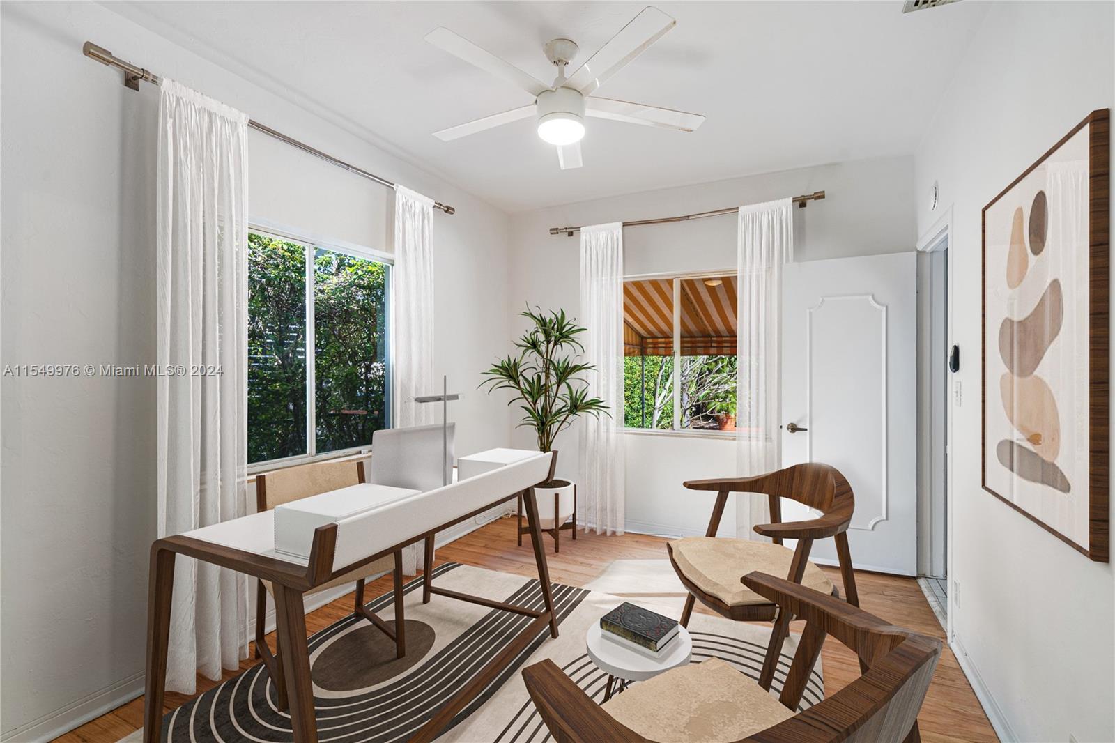 2935 North Bay Road Miami Beach, FL 33140 - Photo 8 of 36 a living room with furniture a window and a potted plant