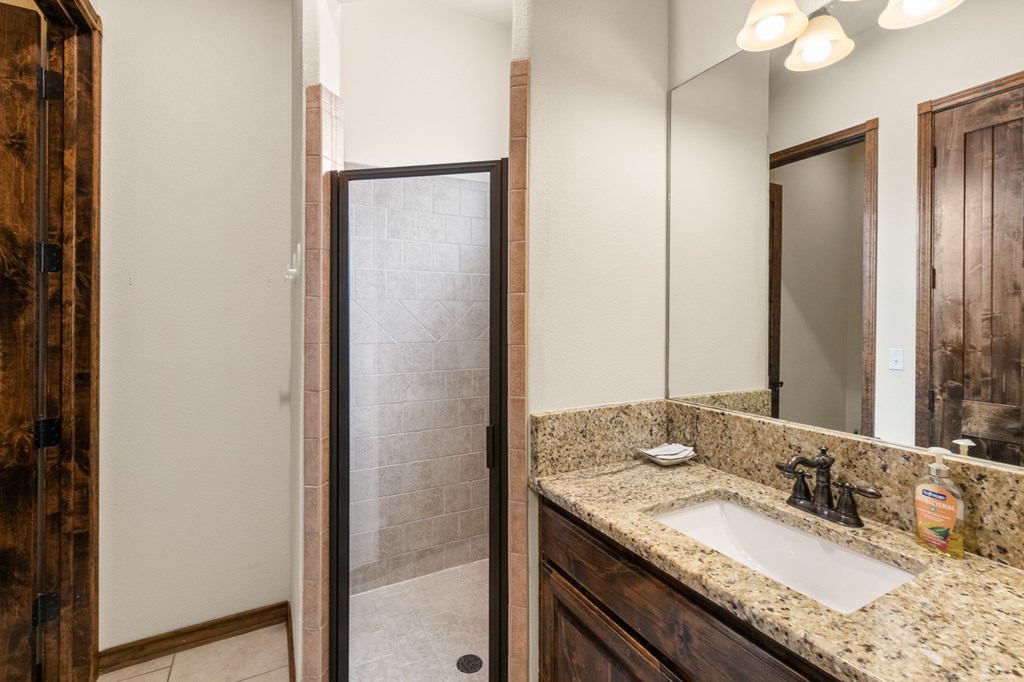 3801-1 Club House Road Kerrville, TX 78028 - Photo 19 of 26 a bathroom with a granite countertop sink and a mirror