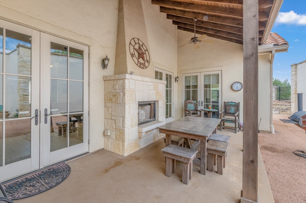 3801-1 Club House Road Kerrville, TX 78028 - Photo 25 of 26 a dining room with furniture and a fireplace