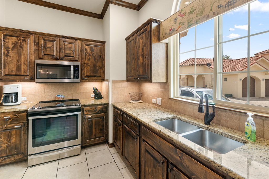 3801-1 Club House Road Kerrville, TX 78028 - Photo 6 of 26 a kitchen with stainless steel appliances granite countertop a sink a stove top oven and granite counter tops