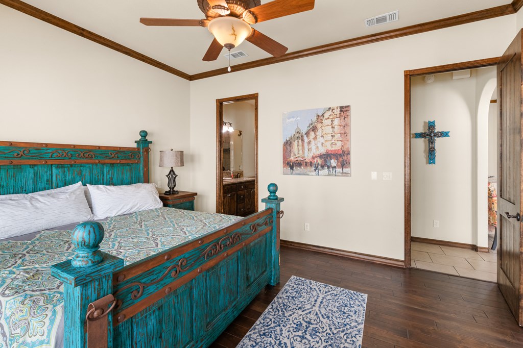 3801-1 Club House Road Kerrville, TX 78028 - Photo 10 of 26 a bed room with a bed and a chandelier