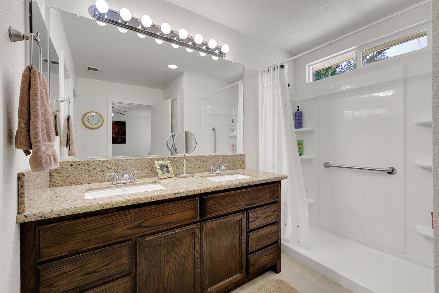 9840 Ellis Way Live Oak, CA 95953 - Photo 29 of 44 a bathroom with a granite countertop sink a large mirror and a shower