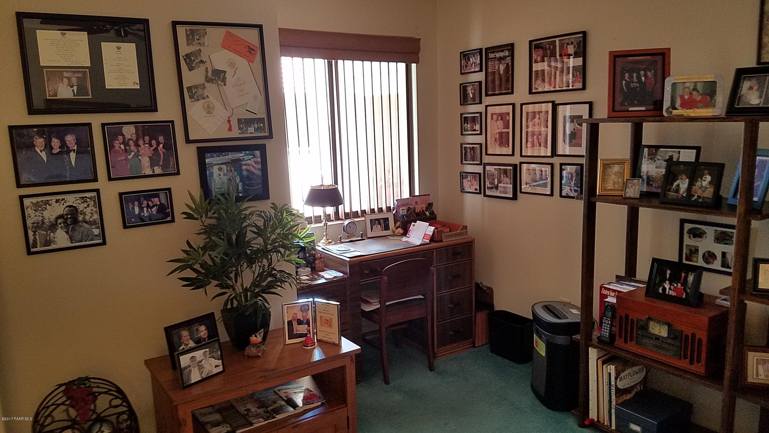428 River Oaks Road Prescott, AZ 86301 - Photo 13 of 17 a view of a workspace with bookshelf and a window