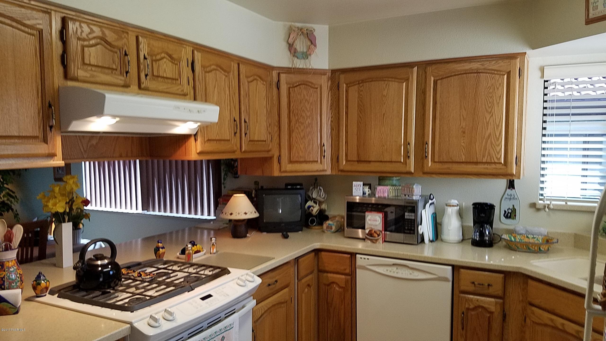 428 River Oaks Road Prescott, AZ 86301 - Photo 5 of 17 a kitchen with stainless steel appliances granite countertop a sink stove and cabinets