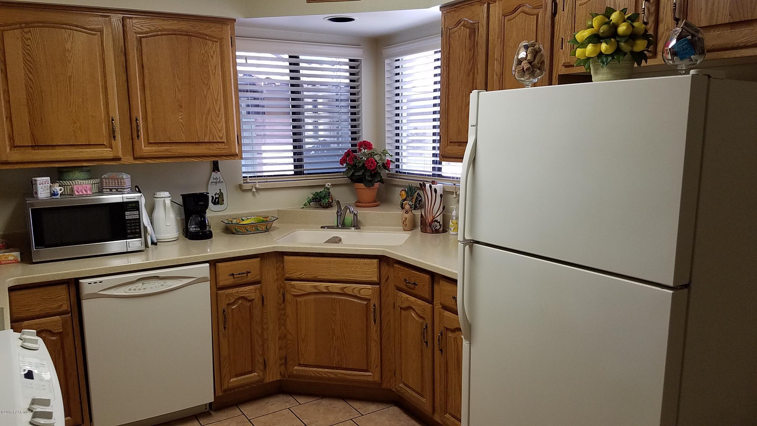 428 River Oaks Road Prescott, AZ 86301 - Photo 6 of 17 a kitchen with a refrigerator sink and cabinets