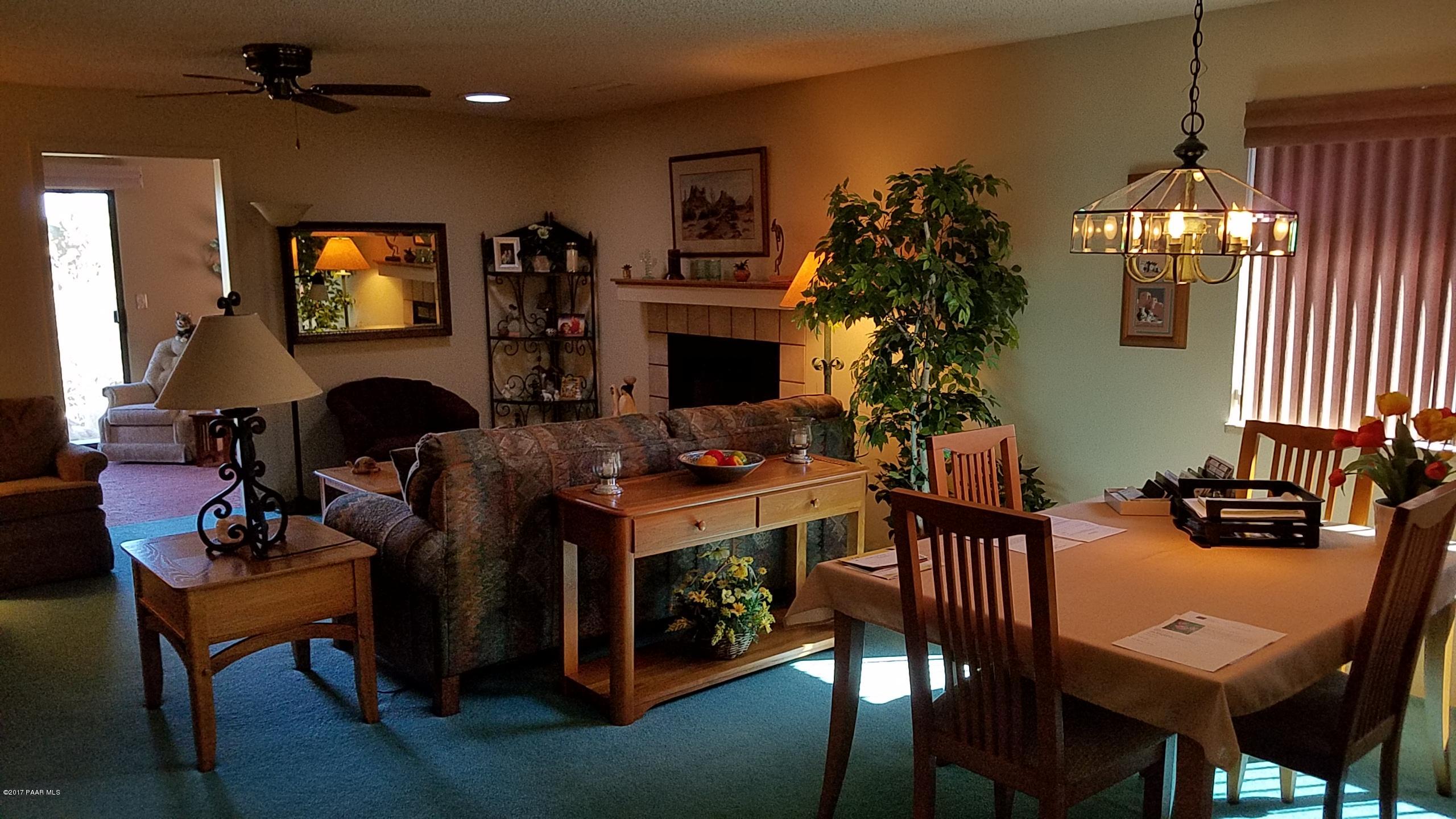 428 River Oaks Road Prescott, AZ 86301 - Photo 7 of 17 a living room with furniture a chandelier and a flat screen tv