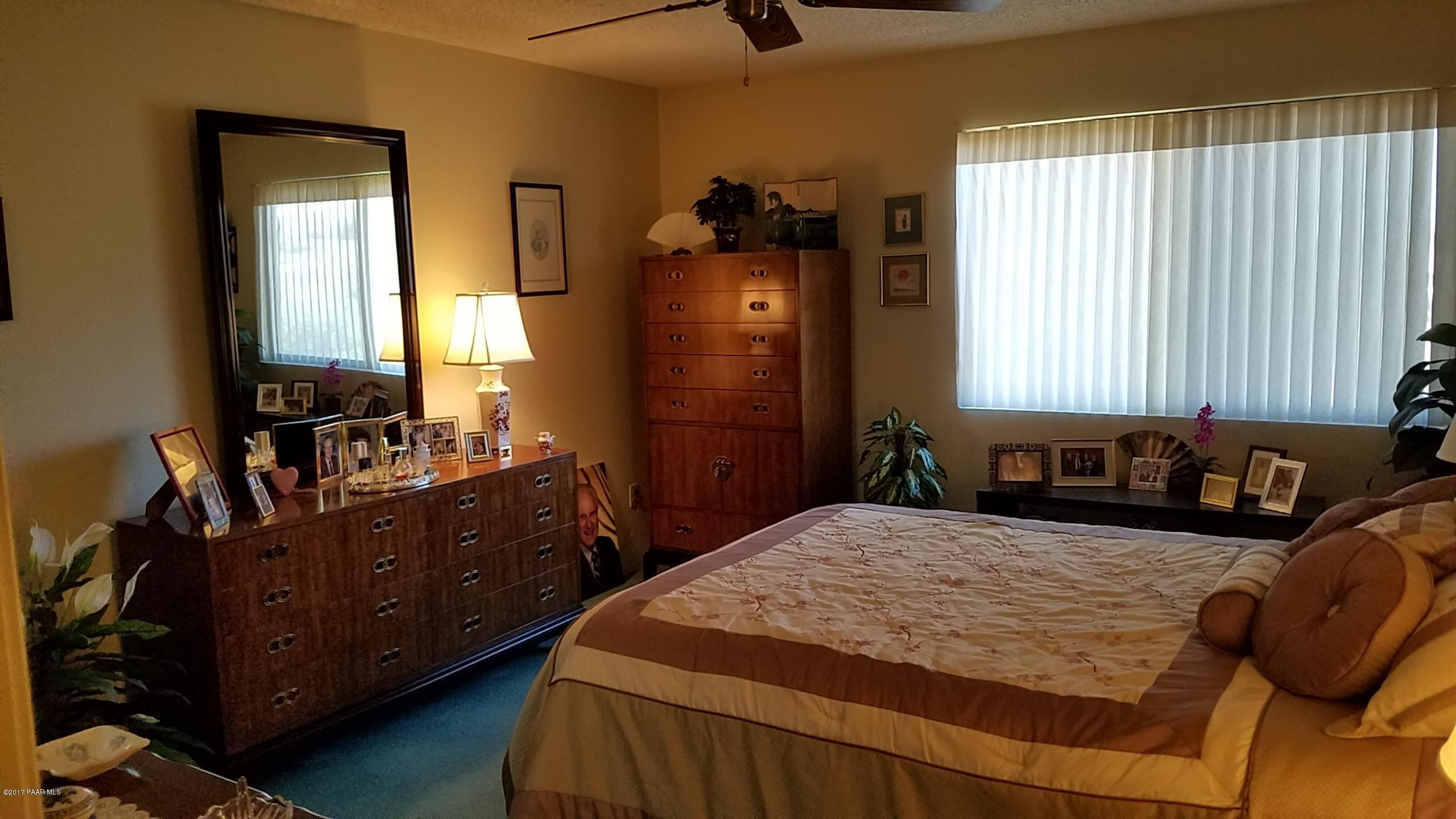 428 River Oaks Road Prescott, AZ 86301 - Photo 9 of 17 a bedroom with a bed and wooden floor