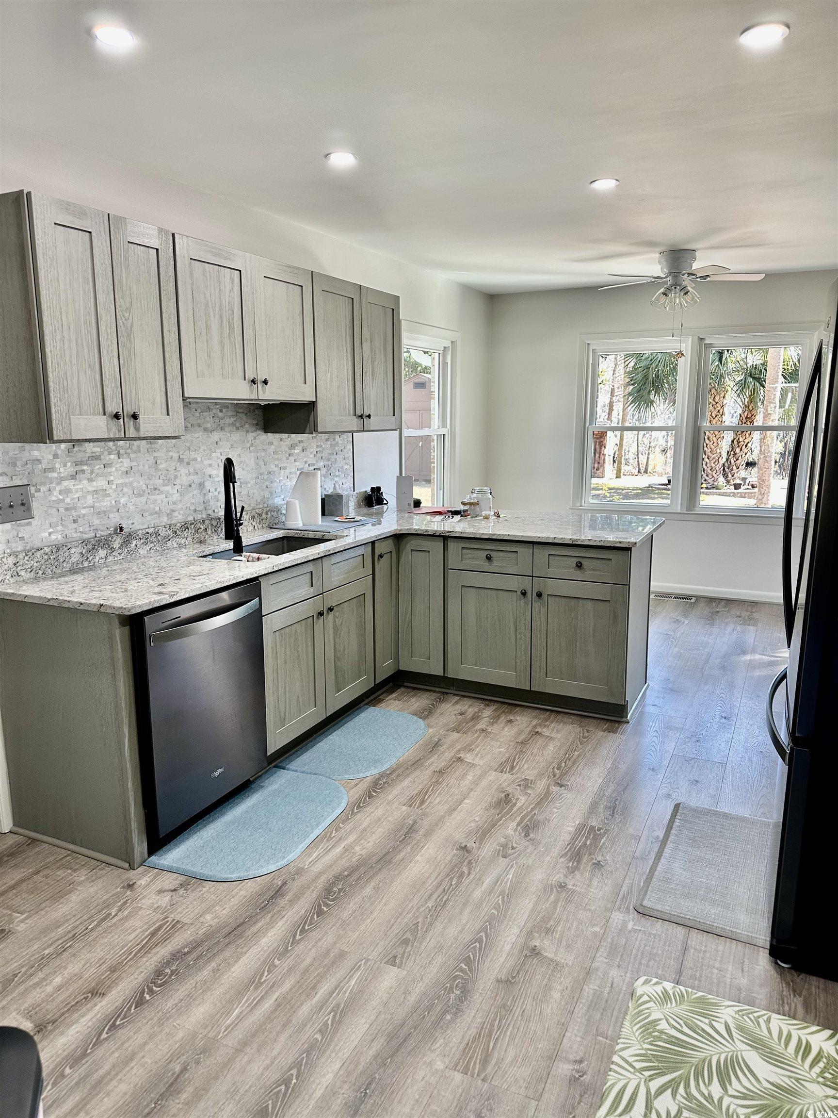 68 Mallard Circle Georgetown, SC 29440 - Photo 18 of 24 Kitchen featuring appliances with stainless steel finishes, light stone counters, and backsplash