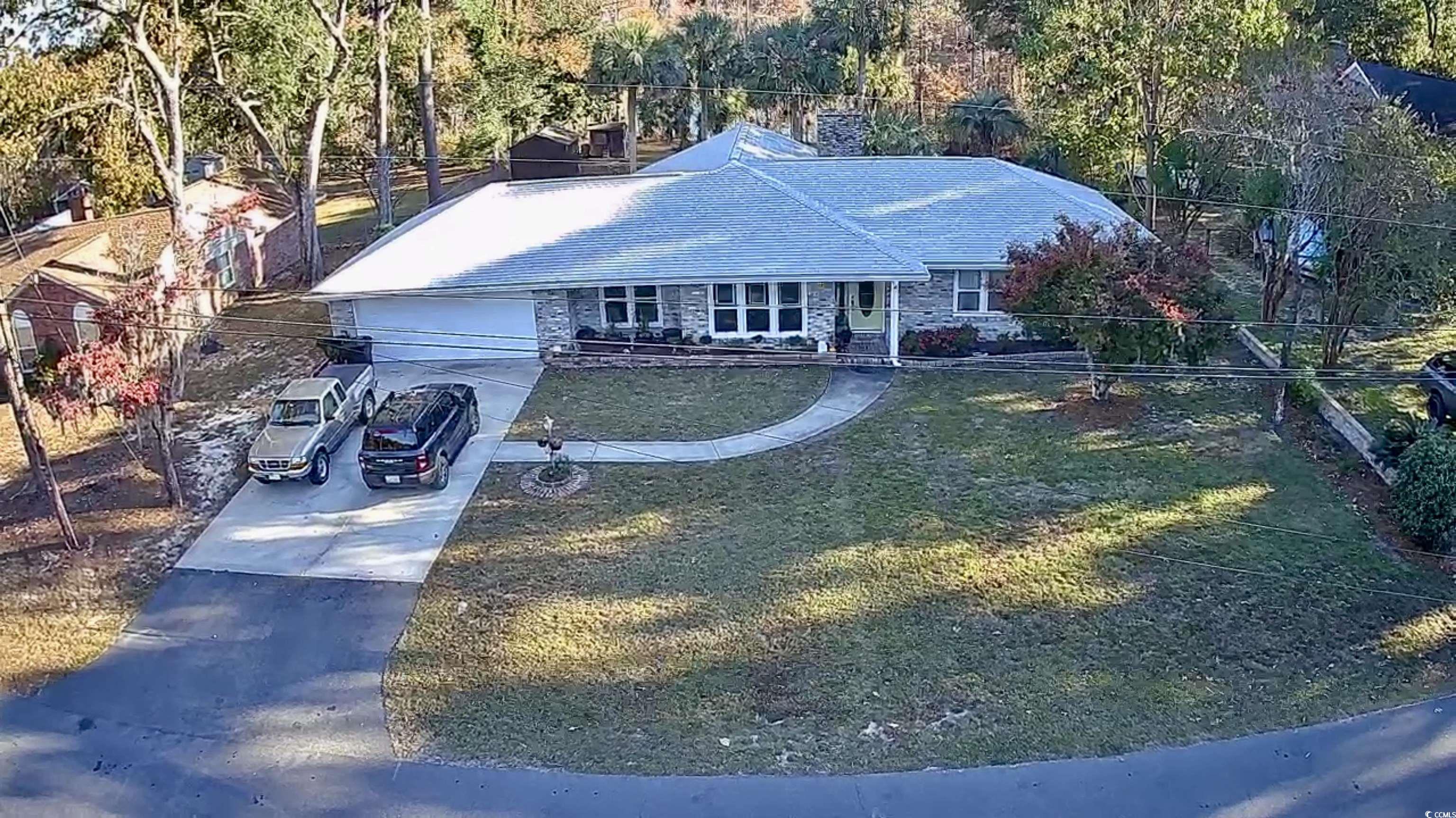 68 Mallard Circle Georgetown, SC 29440 - Photo 2 of 24 Ranch-style house with driveway, a front yard, an attached garage, and stone siding