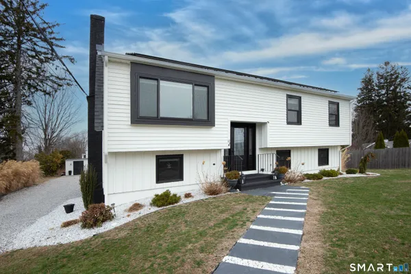 a bedroom with a bed a couch and a window