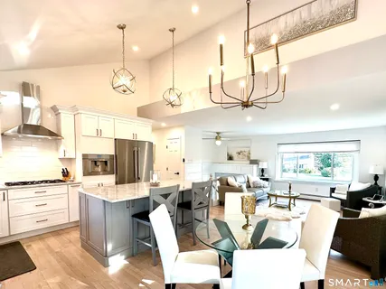 a living room with lots of furniture and kitchen view