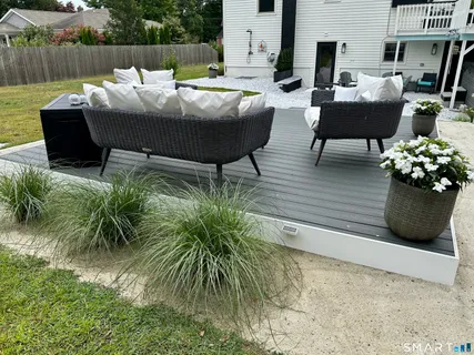 a outdoor sitting area with furniture and wooden floor