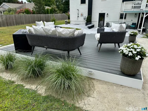 a outdoor sitting area with furniture and wooden floor