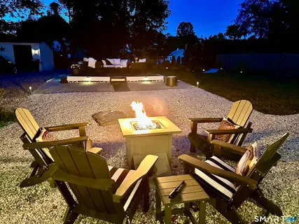 a view of backyard with a table and chairs