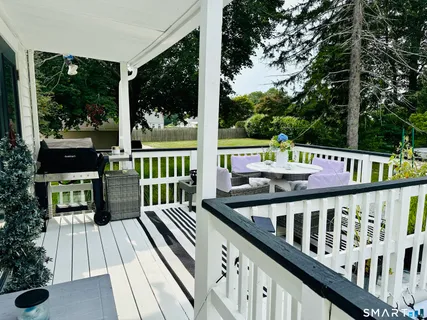 a sign board with a bench and trees