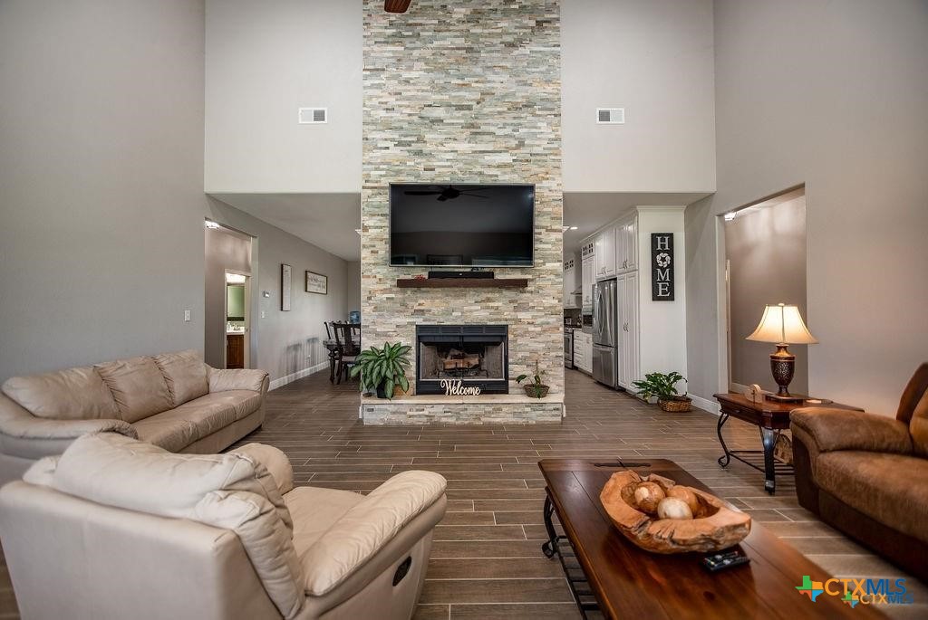 802 Mc Donald Road Port Lavaca, TX 77979 - Photo 12 of 44 a living room with furniture a flat screen tv and a fireplace