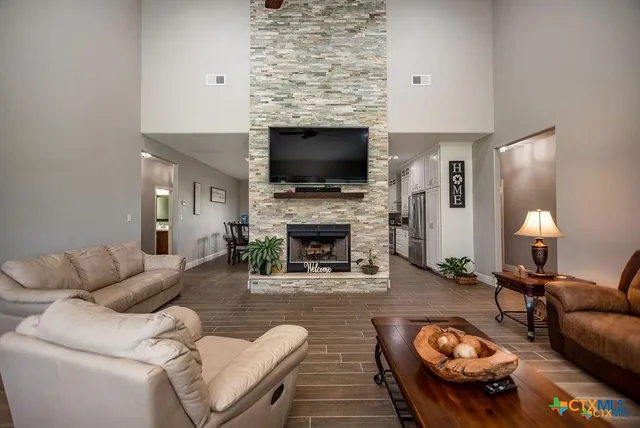 a kitchen with a dining table chairs refrigerator and cabinets