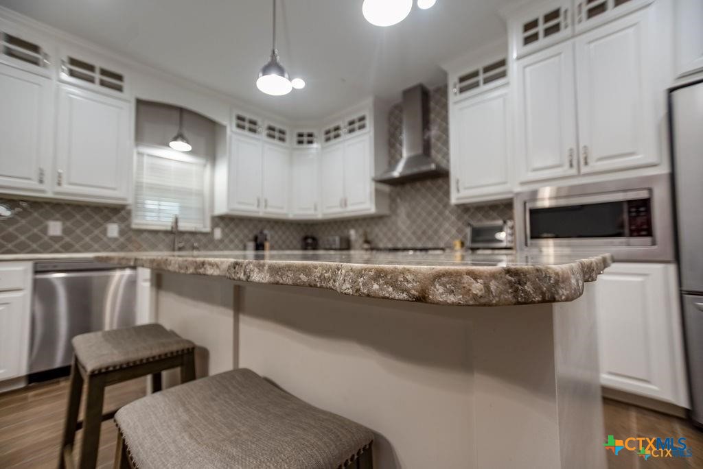802 Mc Donald Road Port Lavaca, TX 77979 - Photo 16 of 45 a kitchen with stainless steel appliances granite countertop a sink a stove and a refrigerator