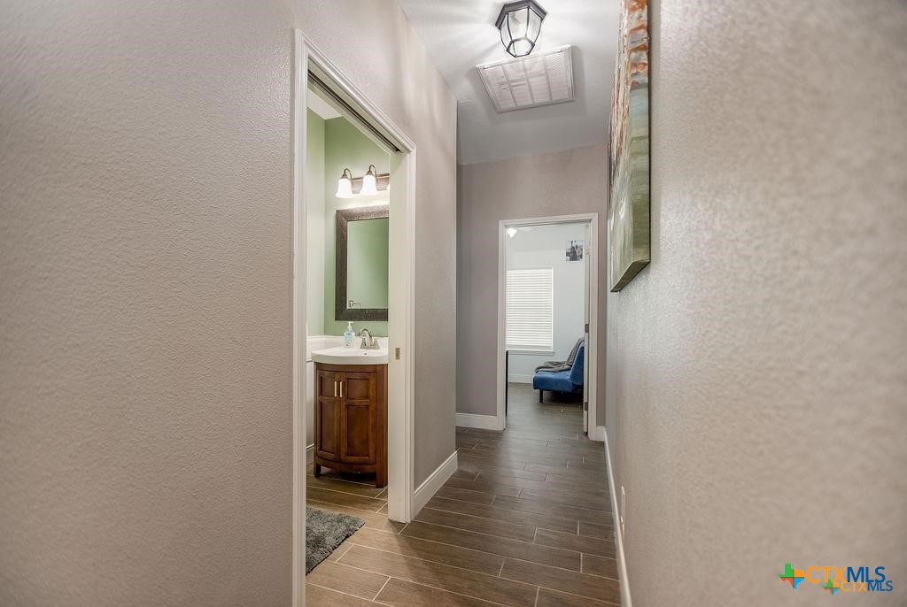 802 Mc Donald Road Port Lavaca, TX 77979 - Photo 19 of 45 a view of a hallway view with wooden floor and staircase