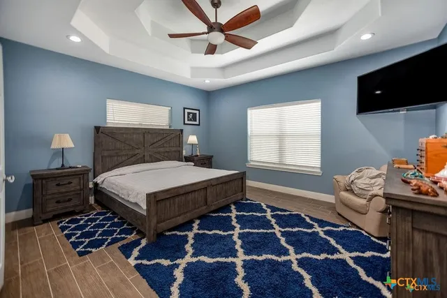 a bedroom with furniture and a flat screen tv