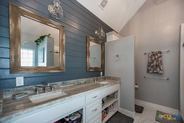 a bathroom with a glass shower door