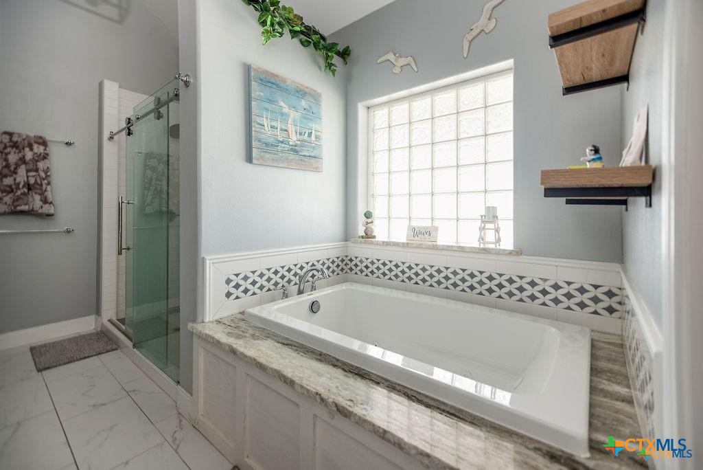 802 Mc Donald Road Port Lavaca, TX 77979 - Photo 27 of 45 a bathroom with a bathtub and a shower