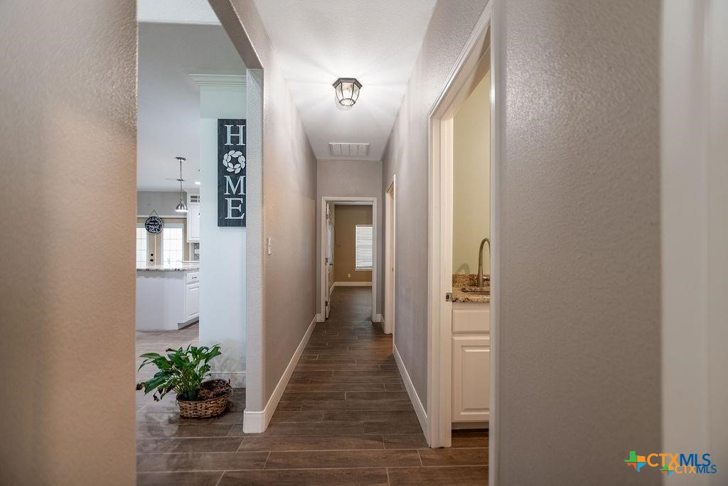 802 Mc Donald Road Port Lavaca, TX 77979 - Photo 28 of 44 a view of a hallway with wooden floor and a potted plant