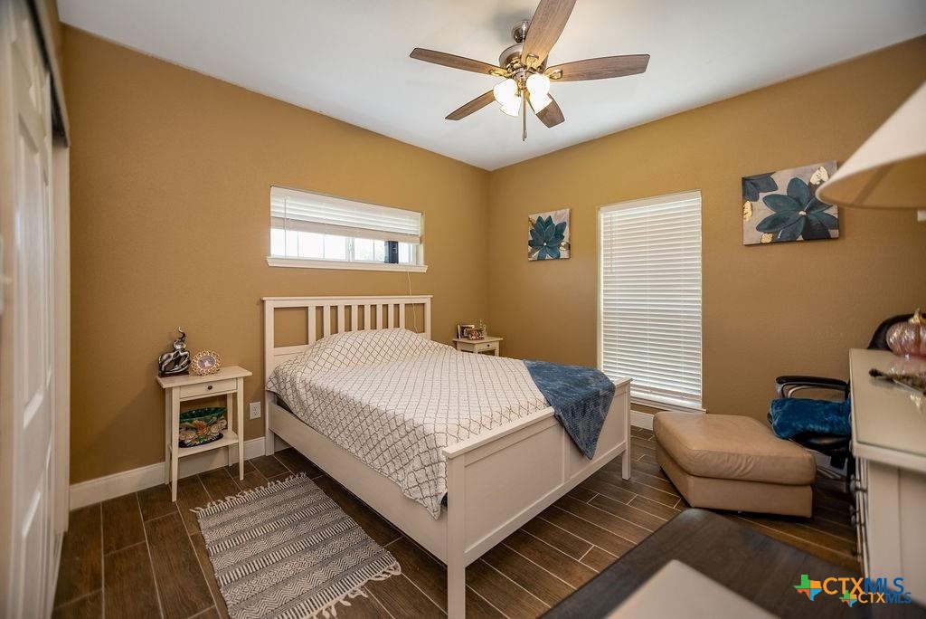 802 Mc Donald Road Port Lavaca, TX 77979 - Photo 30 of 44 a bedroom with a bed rug and wooden floor