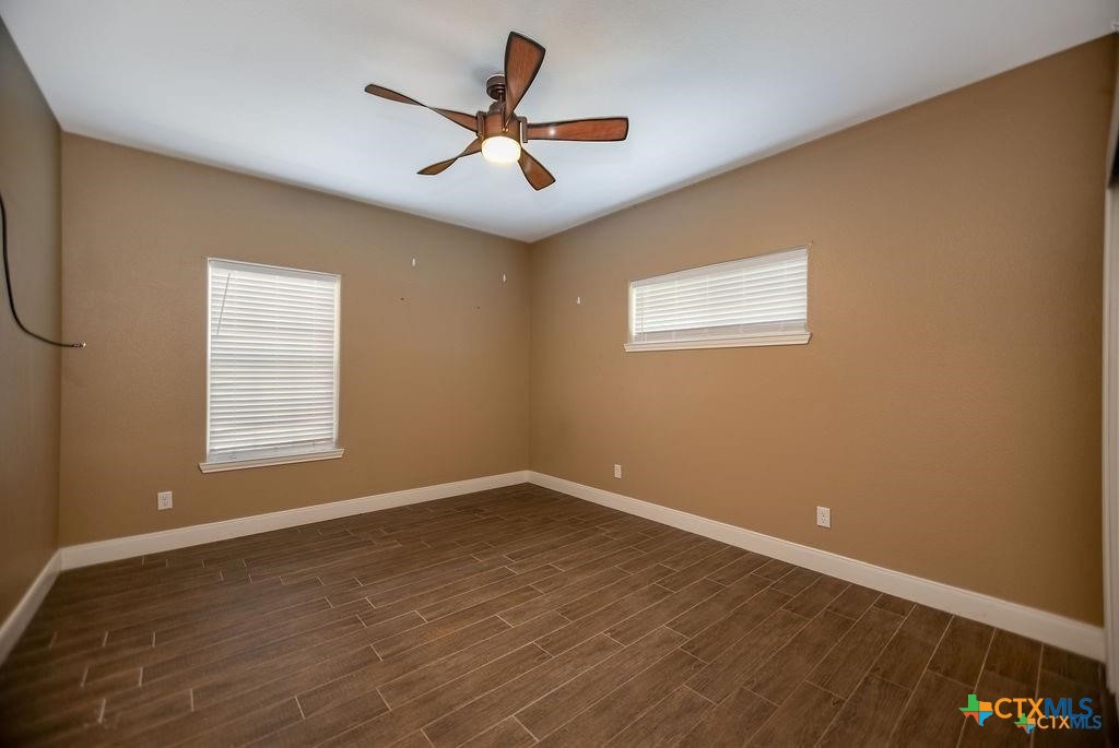802 Mc Donald Road Port Lavaca, TX 77979 - Photo 34 of 44 a view of a big room with wooden floor and windows