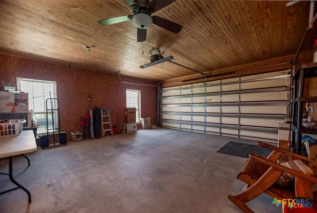 a view of a big house with a big yard and a large tree