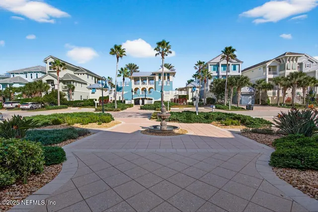 a swimming pool with outdoor seating and plants