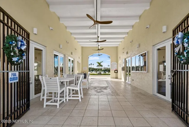 a view of a balcony with furniture and floor to ceiling window