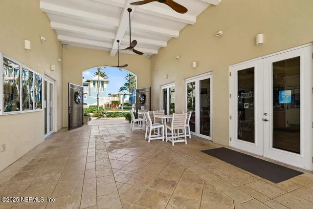a living room with furniture a table and a large window