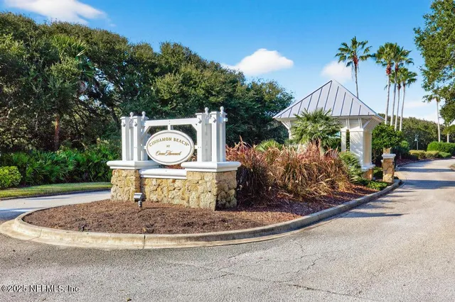 a view of a hallway with wooden floor and closet