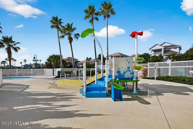 a front view of a house with a yard and potted plants