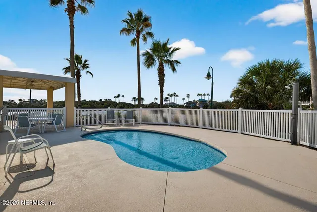 a view of a swimming pool with a table and chairs