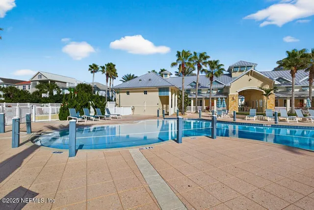 a living room with furniture a rug and a floor to ceiling window