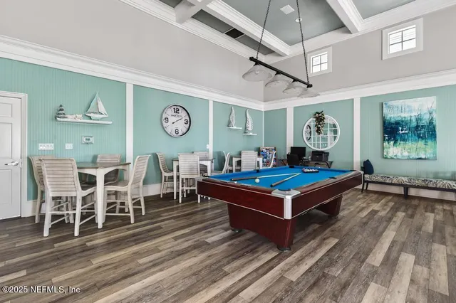 a dining room with furniture and wooden floor